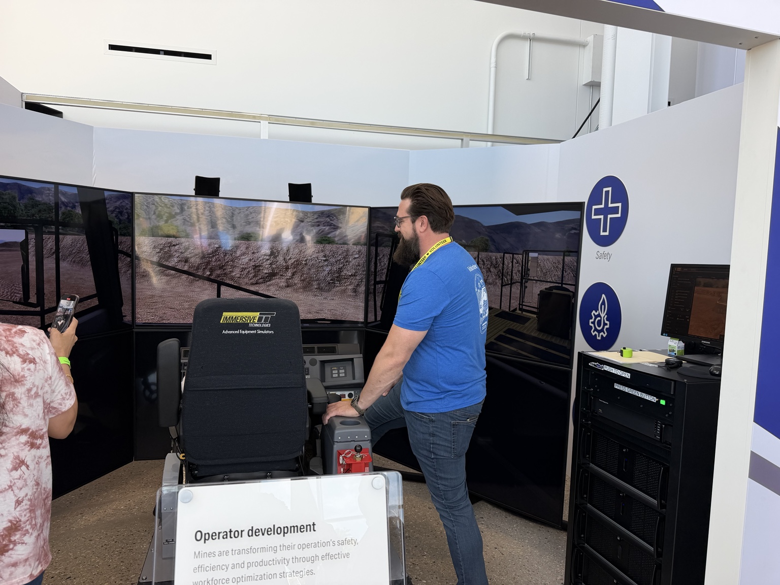 An equipment simulator with an operator’s seat and wraparound screens at Komatsu’s Milwaukee facilities.